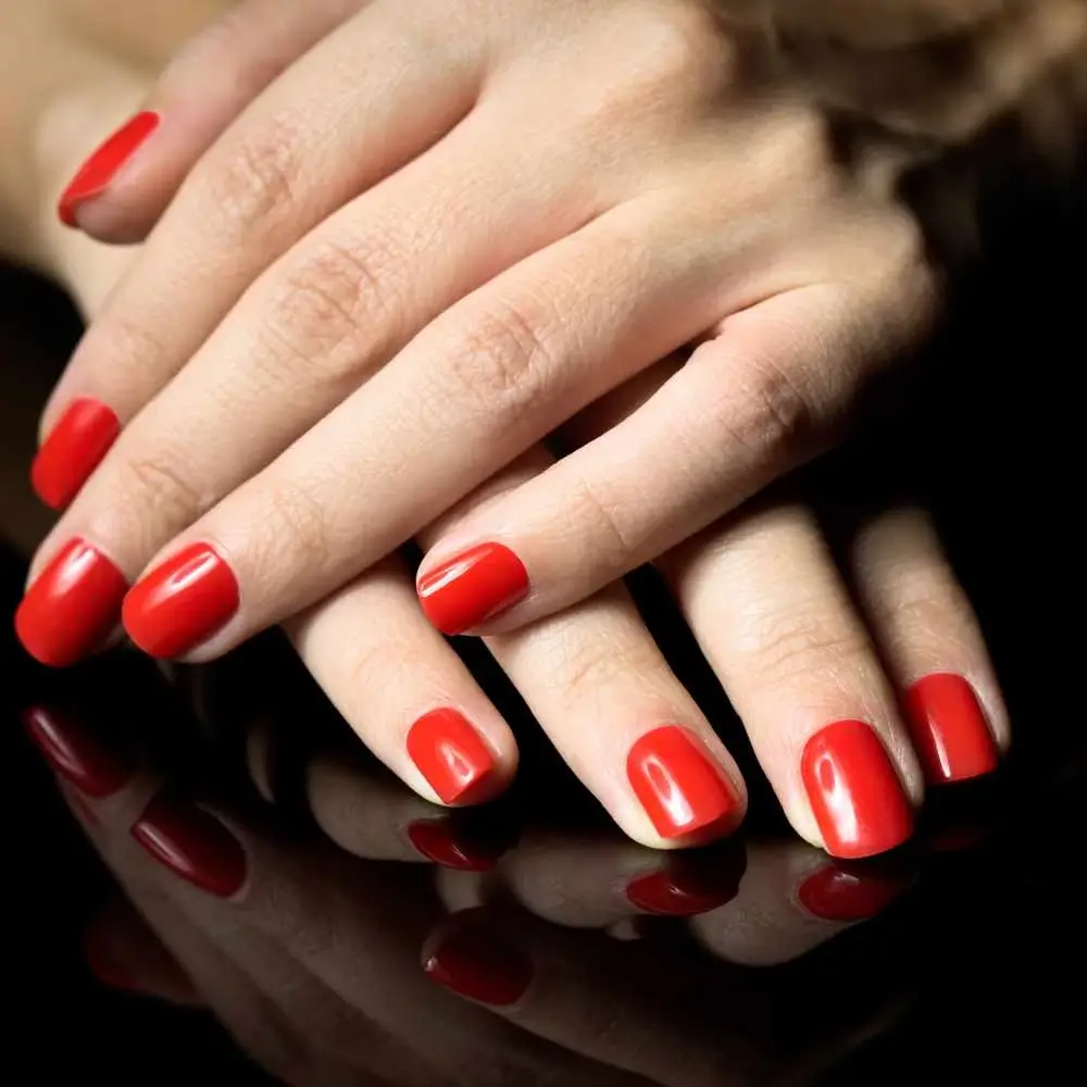 hands painted with red nail polish