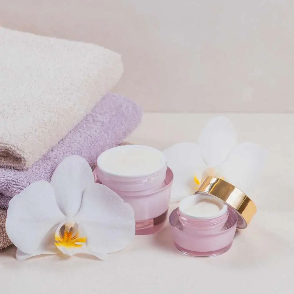 eye creams and white orchid flowers