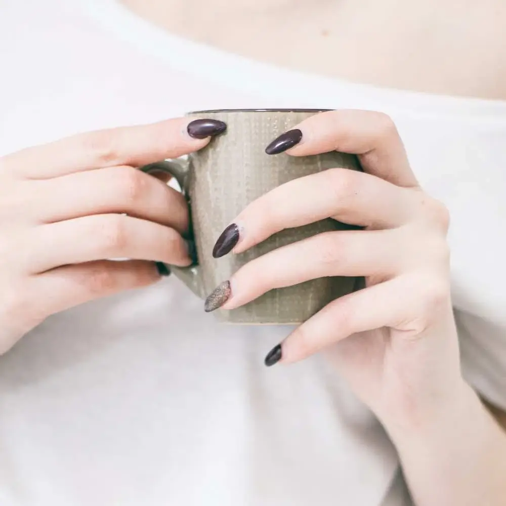  pale-skinned hand modeling a chic black nail color