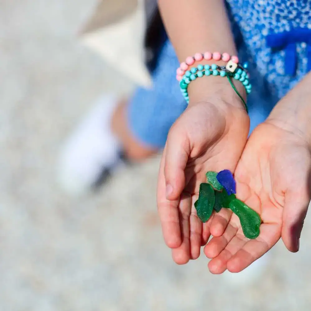 young girl's palm with sea glass