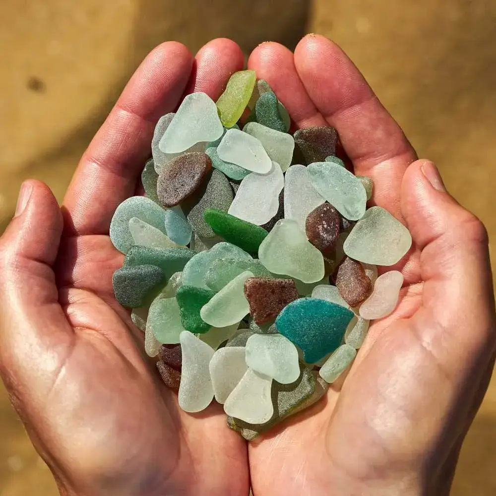 close-up view of palms with sea glass