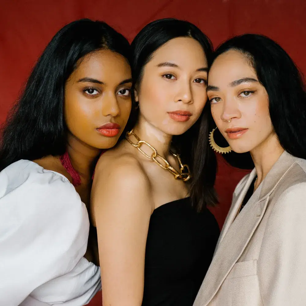 three confident women with makeup