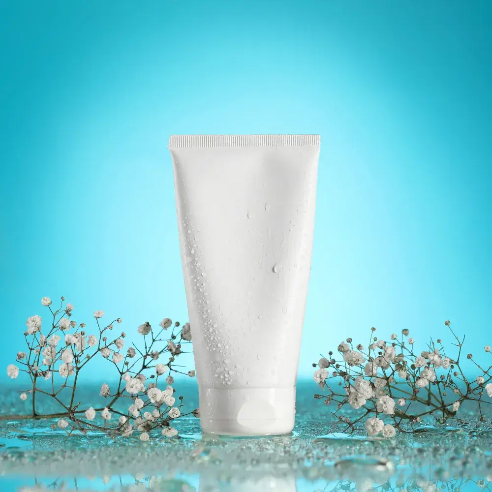 white face wash tube with white flowers in the background