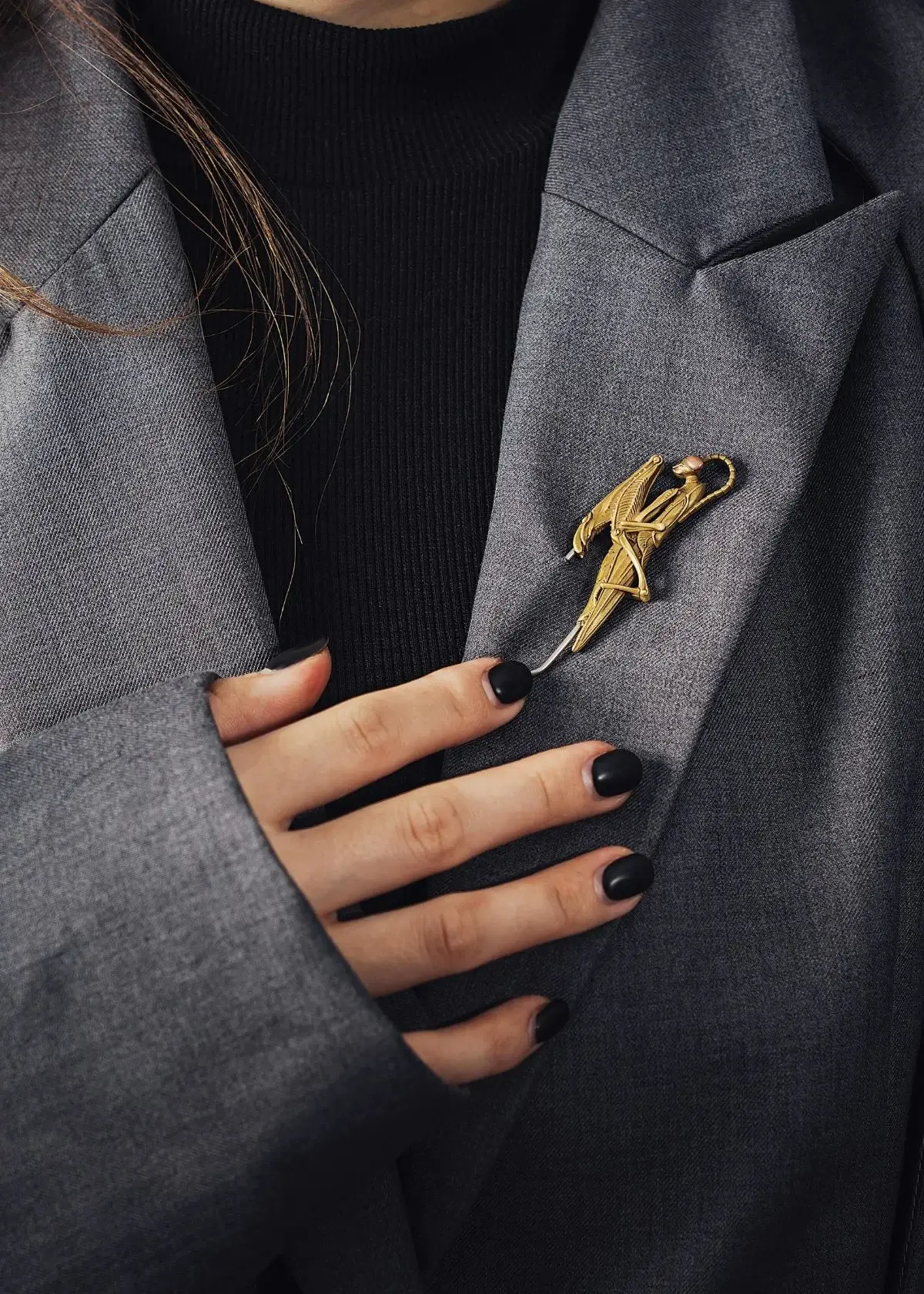 How can I style a brooch or pin to enhance the look?